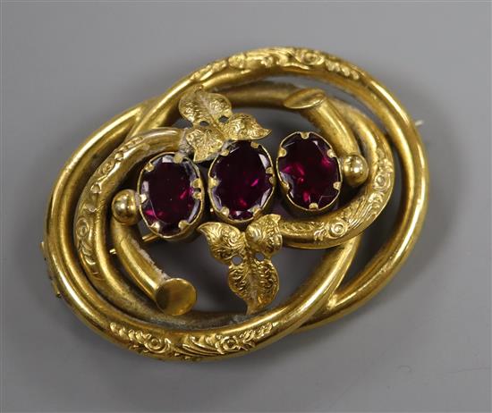 A Victorian pinchbeck and paste set scrolling brooch, 51mm.
